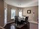 Cozy dining room with dark wood floors and chandelier lighting at 374 W Falcon Ct, Clayton, NC 27520