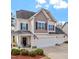 Charming two-story home featuring a well-manicured front yard and a convenient three-car garage at 374 W Falcon Ct, Clayton, NC 27520