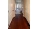 Long hallway features hardwood floors, white doors and trim, and an area rug at 374 W Falcon Ct, Clayton, NC 27520