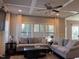 Cozy living room featuring a coffered ceiling, comfortable sofas, and natural light at 374 W Falcon Ct, Clayton, NC 27520