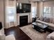 Bright living room with fireplace, large windows, and comfortable seating at 374 W Falcon Ct, Clayton, NC 27520