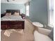 Spacious main bedroom featuring a comfortable bed, natural light, and relaxing sitting area at 374 W Falcon Ct, Clayton, NC 27520