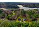A scenic aerial view of a home, nestled in the trees by the lake, with lush greenery and water views at 414 S B Harrison Ln, Henderson, NC 27537