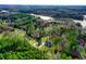 A bird's-eye view captures this lakeside property with mature trees and waterfront access at 414 S B Harrison Ln, Henderson, NC 27537