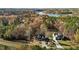 An aerial view revealing two beautiful homes near a lake surrounded by colorful trees at 414 S B Harrison Ln, Henderson, NC 27537