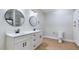Modern bathroom with dual sinks, quartz counters, black fixtures, and storage at 414 S B Harrison Ln, Henderson, NC 27537