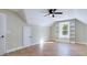 Attic bedroom with wood floors, dormer window with built-in shelving, and neutral paint at 414 S B Harrison Ln, Henderson, NC 27537