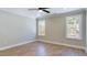 Bright bedroom with wood floors, ceiling fan, and two windows providing natural light at 414 S B Harrison Ln, Henderson, NC 27537