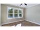 Bright bedroom offering a large window with scenic views of the surrounding trees and landscape at 414 S B Harrison Ln, Henderson, NC 27537