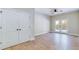 Bright bedroom with wood floors, ceiling fan, back patio access through french doors, and trim detail at 414 S B Harrison Ln, Henderson, NC 27537
