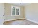 Cozy bedroom features wood floors, a ceiling fan, and a bright window with a peaceful view at 414 S B Harrison Ln, Henderson, NC 27537