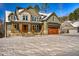 Charming two-story home with a stone and siding exterior and a large front yard covered in snow at 414 S B Harrison Ln, Henderson, NC 27537