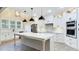 Gourmet kitchen with stainless steel appliances, a large island, and modern pendant lighting at 414 S B Harrison Ln, Henderson, NC 27537