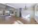 A bright and open-concept living room with hardwood floors and a view of the kitchen at 414 S B Harrison Ln, Henderson, NC 27537