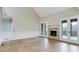 Bright living room features a fireplace with stone accents and access to the outdoor patio at 414 S B Harrison Ln, Henderson, NC 27537