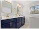 Stylish bathroom features double sink vanity, quartz countertop and modern gold fixtures at 6512 Johnsdale Rd, Raleigh, NC 27615
