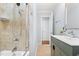 Bathroom boasting a tub/shower combo and modern vanity at 6512 Johnsdale Rd, Raleigh, NC 27615