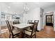 Charming dining room featuring a fireplace, a chandelier, and an open view into the modern kitchen at 6512 Johnsdale Rd, Raleigh, NC 27615
