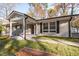 Charming gray brick ranch-style home with a covered front porch and black trim at 6512 Johnsdale Rd, Raleigh, NC 27615
