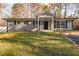 Charming single-story home with a modern painted brick exterior and manicured front lawn at 6512 Johnsdale Rd, Raleigh, NC 27615