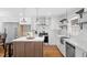 Beautiful kitchen with an island, white cabinets, open shelves, and stainless steel appliances at 6512 Johnsdale Rd, Raleigh, NC 27615