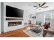 Open floor plan with a modern fireplace and a view into the updated kitchen at 6512 Johnsdale Rd, Raleigh, NC 27615