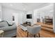 Inviting living room featuring modern furniture, wood floors, and a view into the dining area at 6512 Johnsdale Rd, Raleigh, NC 27615
