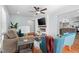 Cozy living room featuring hardwood floors, a ceiling fan, and fireplace with mounted television at 6512 Johnsdale Rd, Raleigh, NC 27615