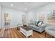 Cozy living room with natural light, comfortable seating, and hardwood floors, creating a welcoming ambiance at 6512 Johnsdale Rd, Raleigh, NC 27615