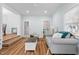Bright living room with hardwood floors, comfortable seating, and natural light from the windows at 6512 Johnsdale Rd, Raleigh, NC 27615