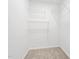 Walk-in closet with carpeted floors and a closet shelving system at 6512 Johnsdale Rd, Raleigh, NC 27615