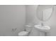 Clean bathroom with a pedestal sink, toilet, and round mirror at 70 Scenic Rock Dr, Youngsville, NC 27596