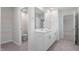Main bathroom with double vanity and access to bedroom at 70 Scenic Rock Dr, Youngsville, NC 27596