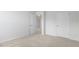 Bright bedroom with neutral walls and carpet, plus a door to hallway at 70 Scenic Rock Dr, Youngsville, NC 27596