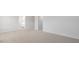 Spacious bedroom with neutral carpeting and access to bathroom at 70 Scenic Rock Dr, Youngsville, NC 27596
