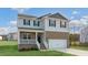Two-story house with brick and vinyl siding, a two-car garage, and a front porch at 70 Scenic Rock Dr, Youngsville, NC 27596