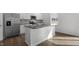 Modern kitchen with white cabinets, granite countertops, and stainless steel appliances at 70 Scenic Rock Dr, Youngsville, NC 27596
