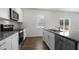 Modern kitchen with white cabinets, granite countertops, and stainless steel appliances at 70 Scenic Rock Dr, Youngsville, NC 27596