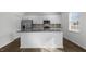 Modern kitchen with white cabinets, granite countertops, and stainless steel appliances at 70 Scenic Rock Dr, Youngsville, NC 27596