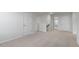 Upstairs hallway with neutral carpeting and multiple doors at 70 Scenic Rock Dr, Youngsville, NC 27596