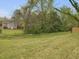 Large grassy backyard featuring mature trees, and a newly-built wooden fence at 734 S State St, Raleigh, NC 27601