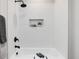 Stylish bathroom featuring a soaking tub and white tiled walls with a shower niche at 734 S State St, Raleigh, NC 27601