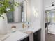 This bathroom features a white countertop, dark cabinets, gold fixtures and decor, and herringbone shower tile at 734 S State St, Raleigh, NC 27601
