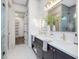 This bathroom features double sinks, white countertops, dark cabinets, and decorative light fixtures at 734 S State St, Raleigh, NC 27601