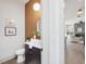 Modern bathroom features a vanity with a unique copper tiled wall and decorative mirror at 734 S State St, Raleigh, NC 27601