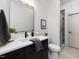 Modern bathroom with dark vanity, walk-in shower, sleek fixtures, and neutral tile flooring at 734 S State St, Raleigh, NC 27601