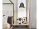 Bedroom detail showcasing a nightstand with decor and a gray pendant light near a large window at 734 S State St, Raleigh, NC 27601