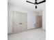 Bedroom with a modern ceiling fan, carpet floors, double doors, and neutral paint at 734 S State St, Raleigh, NC 27601