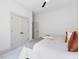 Minimalist bedroom featuring plush carpeting, ceiling fan, and a double door closet at 734 S State St, Raleigh, NC 27601