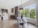 Modern kitchen and dining area with stainless steel appliances and large windows showcasing the backyard at 734 S State St, Raleigh, NC 27601